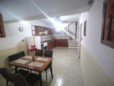 a kitchen and dining room with a table and chairs at Lo de Claudia in Alta Gracia