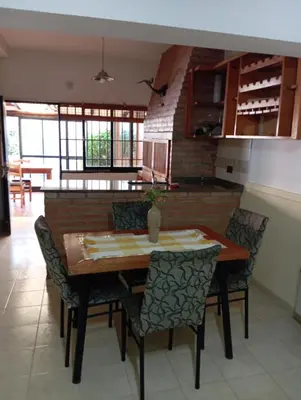 a dining room with a wooden table and chairs at Lo de Claudia in Alta Gracia