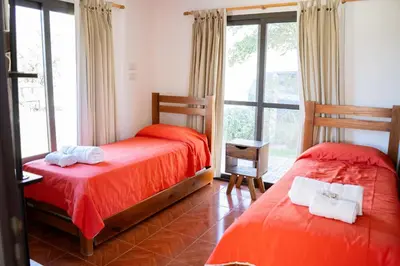 a bedroom with two beds and a window at Complejo Malucos in Pantanillo