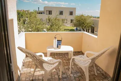 a patio with a table and chairs on a balcony at Complejo Malucos in Pantanillo