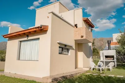 a house in the countryside with two chairs at Complejo Malucos in Pantanillo