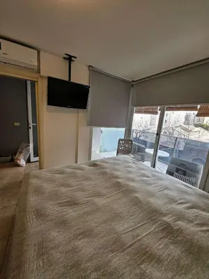 a bedroom with a large bed with a large window at Picasso Nueva Cordoba in Cordoba