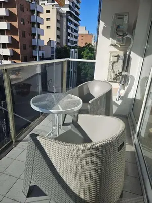 a balcony with a table and chairs on a building at Picasso Nueva Cordoba in Cordoba