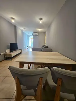 a living room with a wooden table and chairs at Picasso Nueva Cordoba in Cordoba