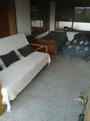 a bedroom with two beds and a lamp at Mágico atardecer in Villa Carlos Paz