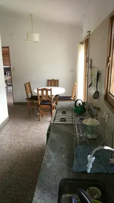 a kitchen with a table and a table and chairs at Mágico atardecer in Villa Carlos Paz