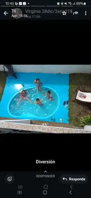 a computer screen with a picture of people in a swimmingpool at Mágico atardecer in Villa Carlos Paz