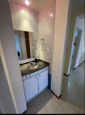 a bathroom with a sink and a large mirror at Departamento -Oro- Frente al Parque Sarmiento, By Apartcba in Cordoba