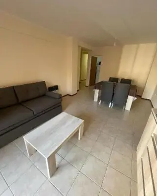 a living room with a couch and a table at Departamento -Oro- Frente al Parque Sarmiento, By Apartcba in Cordoba