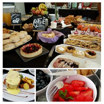 a table filled with different types of food and desserts at Howard Johnson Hotel Piedras Moras in Almafuerte