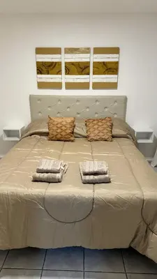 a large bed with two pillows on top of it at Oak Home en Nva Cba in Cordoba