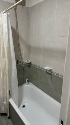 a bathroom with a bath tub with a shower curtain at Oak Home en Nva Cba in Cordoba