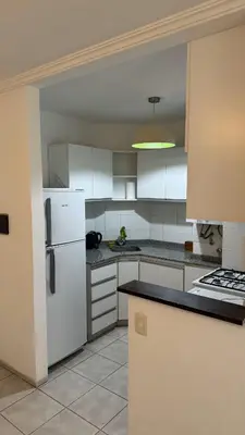 a kitchen with white cabinets and a white refrigerator at Oak Home en Nva Cba in Cordoba