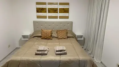 a bedroom with a bed with two pillows on it at Oak Home en Nva Cba in Cordoba