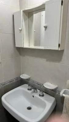 a bathroom with a white sink and a cabinet at Oak Home en Nva Cba in Cordoba