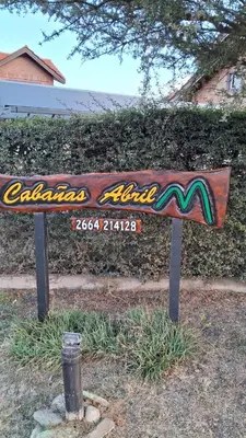 a wooden bench sitting in the middle of a park at Cabañas Abril in Merlo