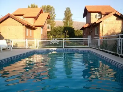 a swimming pool in the backyard of a house at Cabañas Abril in Merlo