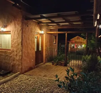 a front door of a house at night at Cabañas La Ruka in Los Reartes