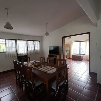 a dining room with a wooden table and chairs at Excepcional Casa de campo in Villa Anizacate