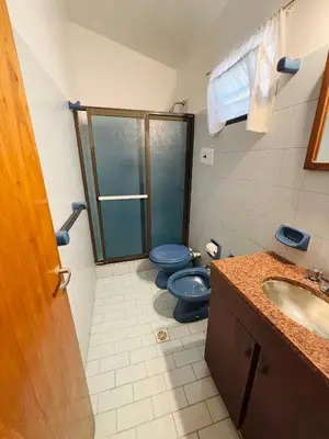 a bathroom with two blue toilets and a sink at Departamentos Pasini in Villa Carlos Paz