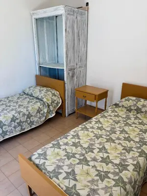a room with two beds and a window at Departamentos Pasini in Villa Carlos Paz