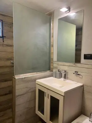 a bathroom with a sink and a mirror and a toilet at Departamento en el centro in Cordoba