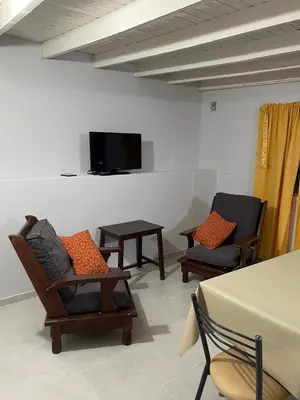 a living room with two chairs and a flat screen tv at Casa en San Francisco del monte de oro in San Francisco del Monte de Oro