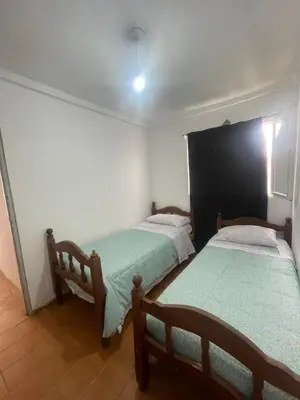 two twin beds in a room with a window at Casa en San Francisco del monte de oro in San Francisco del Monte de Oro