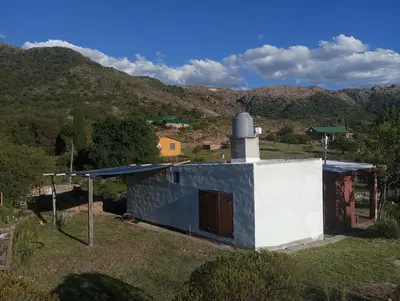 a small house with a tower on top of it at la balsa in Mina Clavero