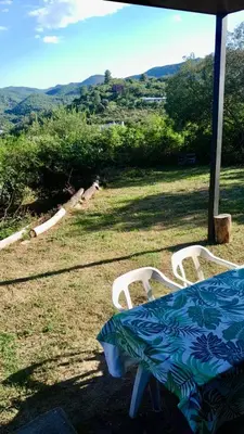 a table and chairs in a field with a view at Casa Safari en La Paisanita, Alta Gracia in Alta Gracia