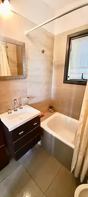 a bathroom with a sink and a bath tub at Casa Safari en La Paisanita, Alta Gracia in Alta Gracia