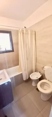 a bathroom with a toilet and a sink and a shower at Casa Safari en La Paisanita, Alta Gracia in Alta Gracia