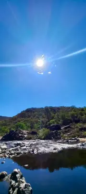 a plane flying in the sky over a body of water at Casa Safari en La Paisanita, Alta Gracia in Alta Gracia