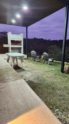 a picnic table and two chairs under a tent at Casa Safari en La Paisanita, Alta Gracia in Alta Gracia