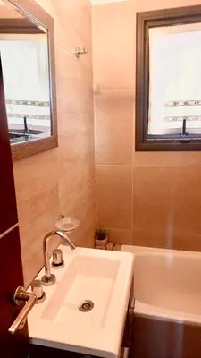 a bathroom with a sink and a tub and a window at Casa Safari en La Paisanita, Alta Gracia in Alta Gracia