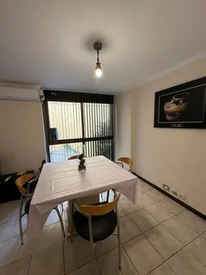 a dining room with a white table and chairs at Departamento 1 dorm con cochera Nueva Córdoba 1 E INVERHOME INMOBILIARIA in Cordoba