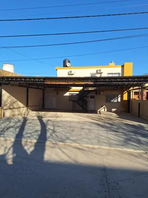 a building with a shadow of a pole in front of it at Hospedaje Champaqui in Santa Rosa de Calamuchita