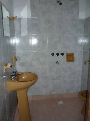 a bathroom with a sink and a shower at Hospedaje Champaqui in Santa Rosa de Calamuchita