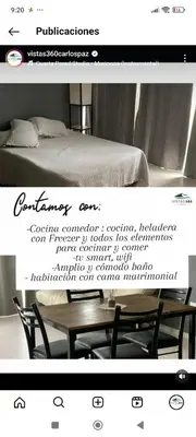 a picture of a bed and a table and chairs at Vistas360carlospaz in Villa Carlos Paz