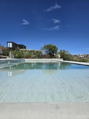 a large pool of water with a blue sky at Vistas360carlospaz in Villa Carlos Paz