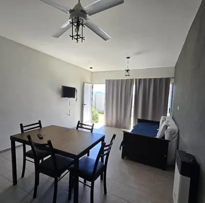 a living room with a dining room table and a bed at Vistas360carlospaz in Villa Carlos Paz