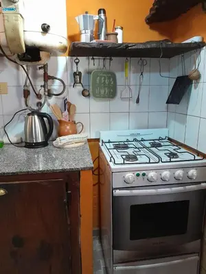 a kitchen with a stove top oven in a kitchen at Casita en Los Hornillos in Los Hornillos