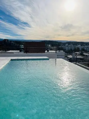 a swimming pool on the roof of a building at Depto 