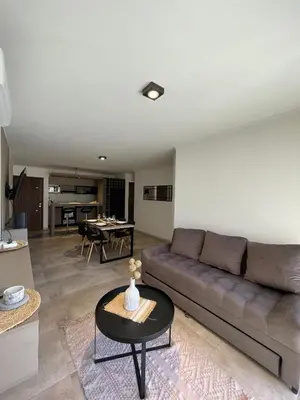 a living room with a couch and a table at Depto 