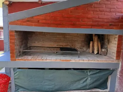 a brick oven with a bunch of logs in it at Complejo soñado in Mina Clavero
