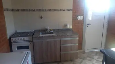 a small kitchen with a stove and a sink at Complejo soñado in Mina Clavero