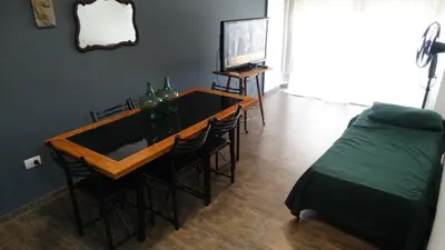 a room with a table and chairs and a bed at Alquiler día Nueva Cordoba in Cordoba