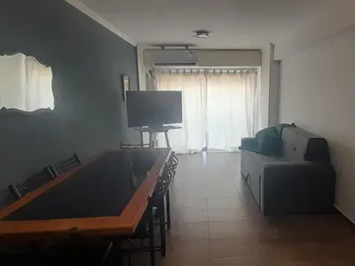 a living room with a couch and a tv at Alquiler día Nueva Cordoba in Cordoba
