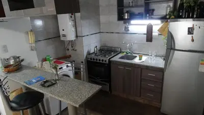 a small kitchen with a stove and a refrigerator at Alquiler día Nueva Cordoba in Cordoba