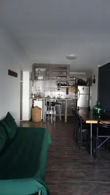 a living room with a couch and a table and a kitchen at Alquiler día Nueva Cordoba in Cordoba
